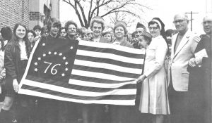 Sr. Mary Fidelis, Principal of St. Barbara School, with Rev. Thaddeus Wypijewski and others as St. Barbara School accepts the donation of a Bennington flag from the VFW Ford Dearborn Post 1494 during the nation’s Bicentennial celebration. From St. Barbara Parish 1924 – 1983. Courtesy of Judi Kadela.